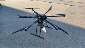 Hexacopter drone on ground side view, IceConeFeed S-Band 2490 MHz antenna mounted underneath for ESA indoor navigation test campaign