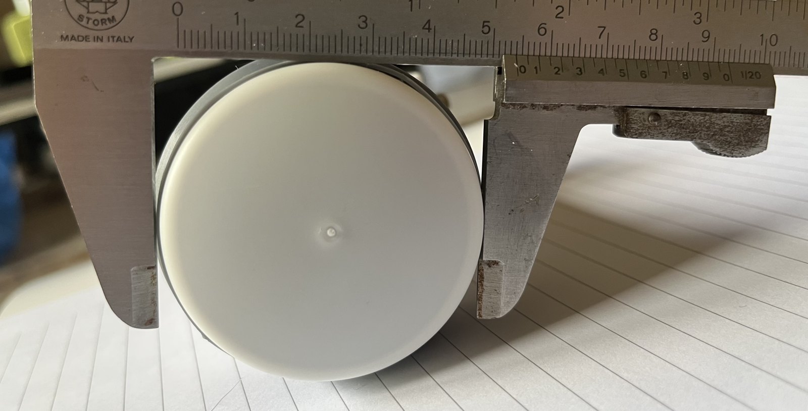 A DX-Patrol LNB held in a vernier caliper, measured at the front neck at about 53 mm.